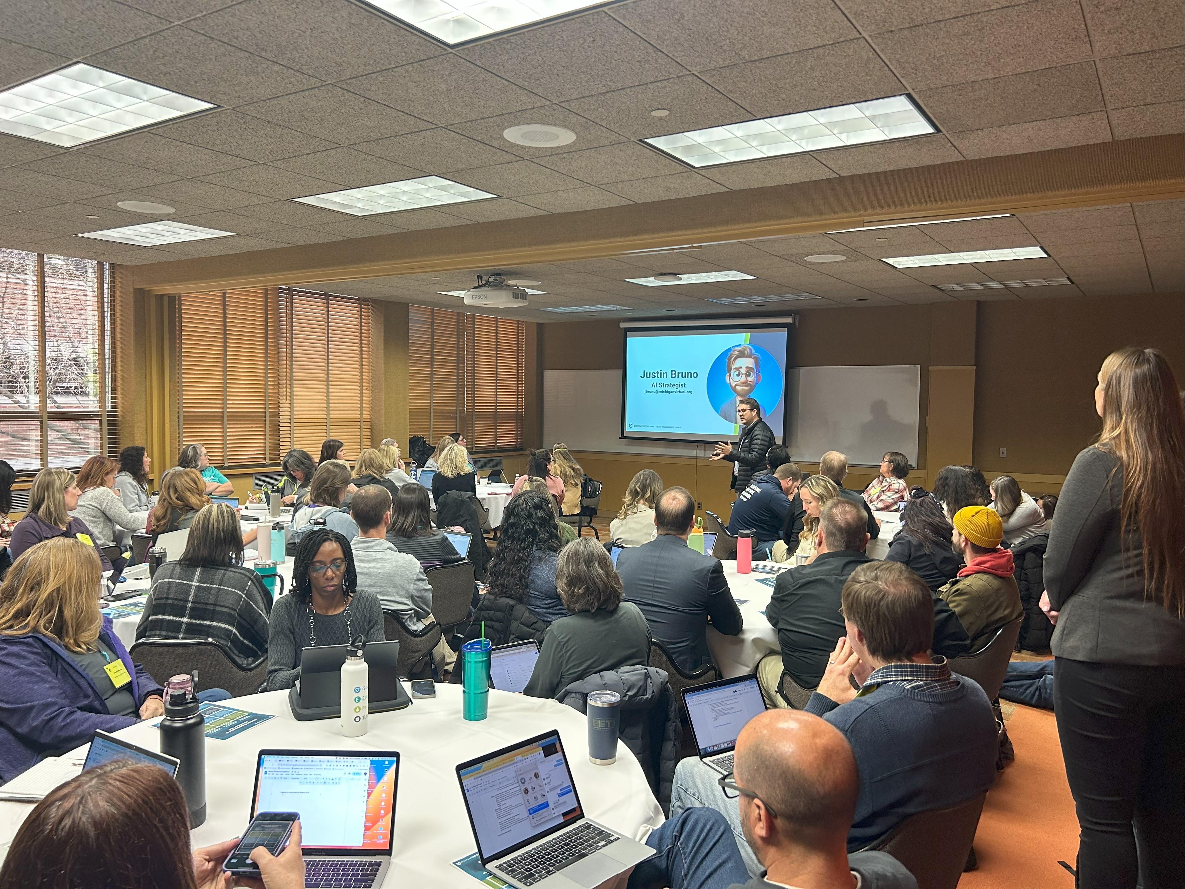AI Strategist, Justin Bruno, speaking at an anchor session to a group of people.